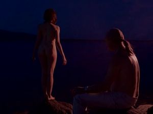 Голая девка стоит ночью на берегу озера